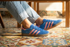 A women wearing Adidas Gazelle Indoor Shoes in a restaurant