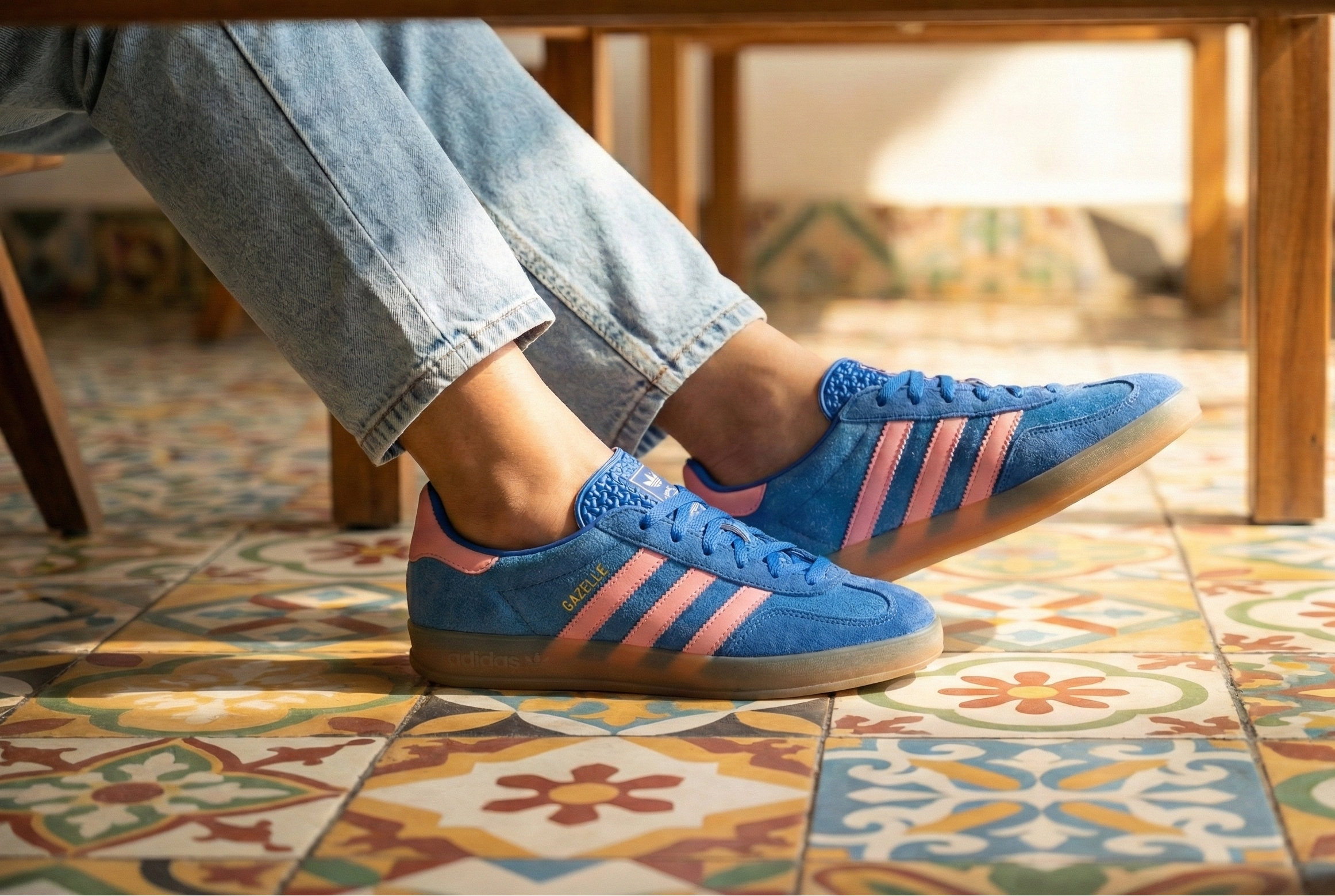 A women wearing Adidas Gazelle Indoor Shoes in a restaurant