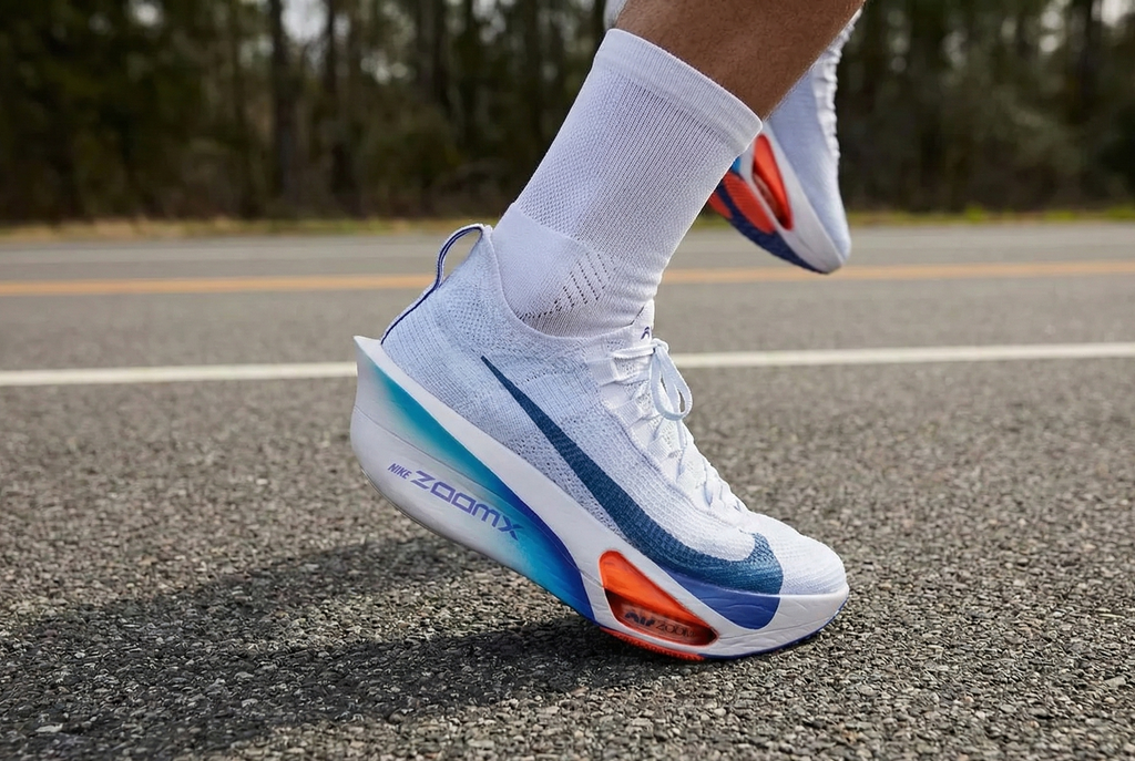 Person wearing Nike Alphafly 3 running shoes with blue and orange accents on a road. Luxuntique Sri Lanka