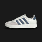 Adidas Barreda shoes in Off White, Preloved Ink, and Grey One (JR1318). Features a classic court-inspired profile with a durable synthetic upper, breathable perforations, and a supportive rubber cupsole for stability. Luxuntique guarantees 100% authentic "Adidas" footwear in Sri Lanka.