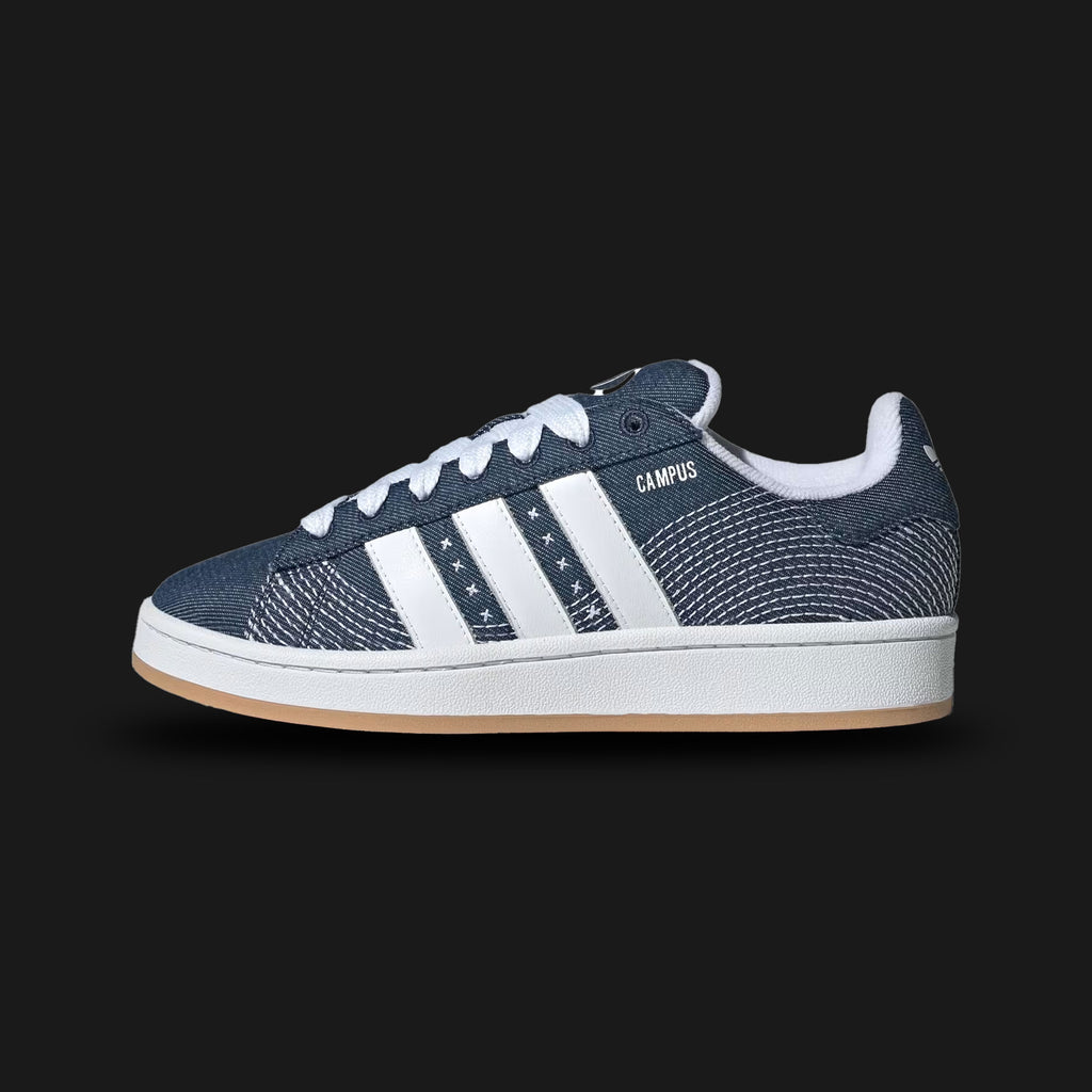 Adidas Campus 00s shoes in Blue, Dark Blue, and Cloud White (JQ5782). Features a premium blue suede upper with exaggerated Dark Blue serrated 3-Stripes and extra-wide "fat" laces. Reimagined Y2K skate-inspired silhouette with a heavily padded tongue and a durable white rubber cupsole. Luxuntique offers 100% authentic Adidas in Sri Lanka.