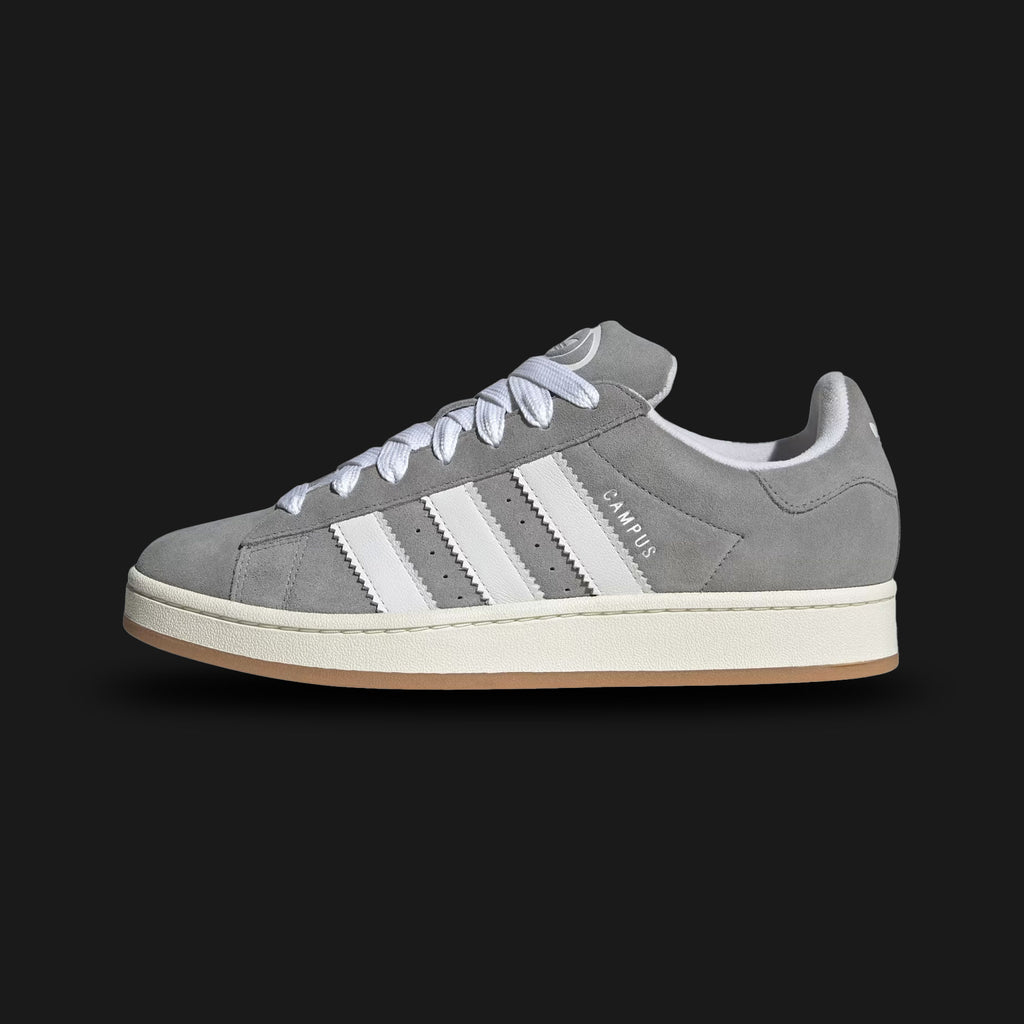 Adidas Campus 00s shoes in Grey Three, Cloud White, and Off White (HQ8707). Features a chunky Y2K skate-inspired silhouette with a premium Grey Three suede upper and oversized Cloud White 3-Stripes. Includes fat laces, a heavily padded tongue, and an Off White vintage-style rubber cupsole. Luxuntique guarantees 100% authentic Adidas footwear in Sri Lanka.