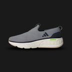 Adidas Cloudfoam Go Lounger shoes in Grey Three, Core Black, and Off White (ID4021). Features a laceless textile upper with suede overlays, plush Cloudfoam cushioning midsole, and a durable rubber outsole for easy slip-on comfort. Luxuntique guarantees 100% authentic footwear.