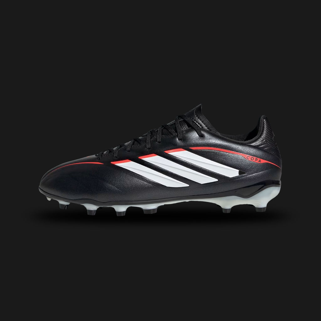 Adidas Copa Pure IV League Firm Ground kids football boots in Core Black, Cloud White, and Lucid Red (JR6265). Features a comfortable synthetic leather upper with classic forefoot stitching for enhanced ball touch. Includes crisp Cloud White 3-Stripes, a U-throat collar for easy entry, and a durable Firm Ground (FG) soleplate with Lucid Red stud accents. Luxuntique guarantees 100% authentic Adidas footwear in Sri Lanka.