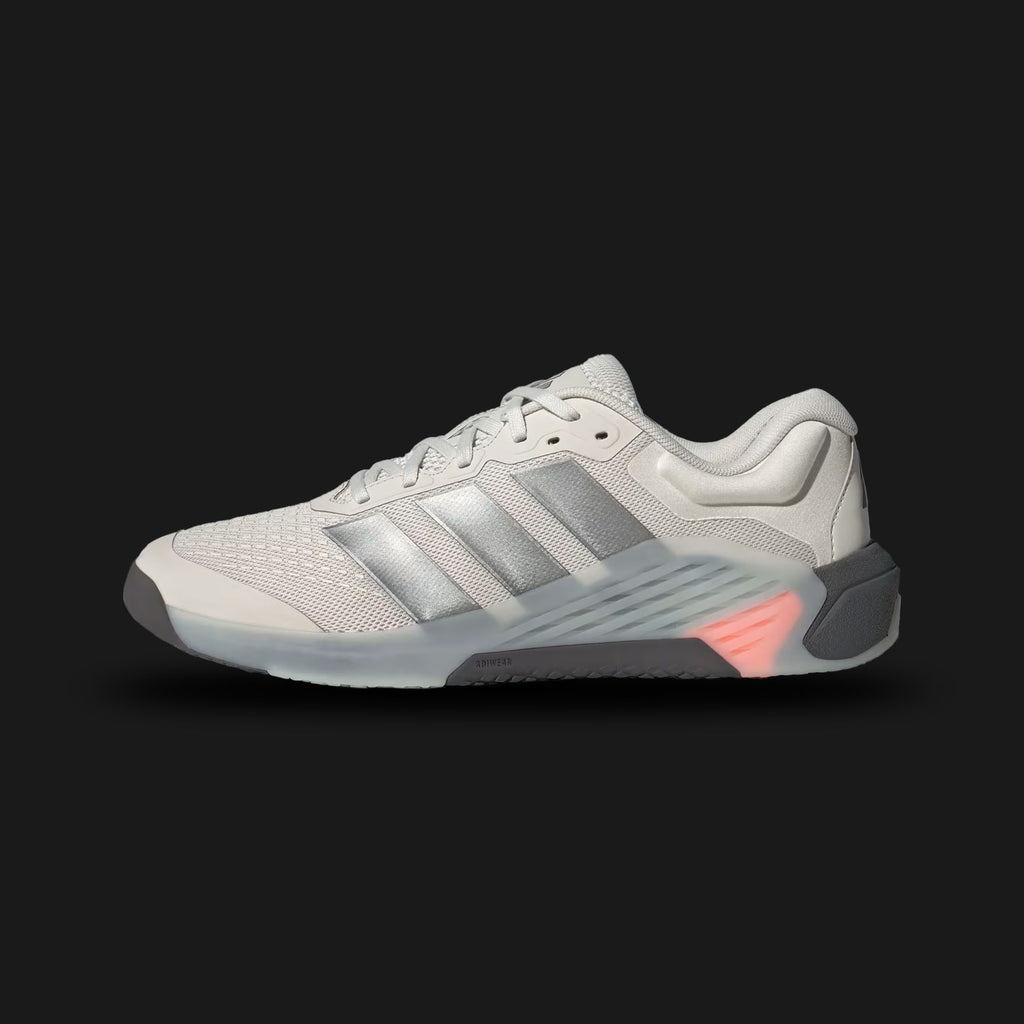 Adidas Dropset 4 Training Shoes in Orbit Grey, Iron Metallic, and Lucid Orange (JR4678). Features a dual-density midsole with a firm heel for lifting stability and a soft forefoot for agility. Includes a wide toe-box for toe splay, breathable mesh upper with Iron Metallic TPU side-wall support, and a high-traction Adiwear outsole. Luxuntique offers 100% authentic Adidas in Sri Lanka.