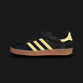 Adidas Gazelle Indoor shoes in Core Black, Almost Yellow, and Gum (IG4999). Features a premium suede upper with a classic T-toe overlay, soft leather Three-Stripes, and the iconic semi-translucent gum rubber cupsole. Luxuntique guarantees 100% authentic "Adidas" footwear in Sri Lanka.
