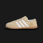 Adidas Gazelle Lo Pro shoes in Sand Strata, Cloud White, and Gum (JR8889). Features a premium Sand Strata tan suede upper with crisp white leather Three Stripes and gold foil branding. Designed with a streamlined, ultra-low profile gum rubber outsole. Luxuntique offers 100% authentic Adidas in Sri Lanka.