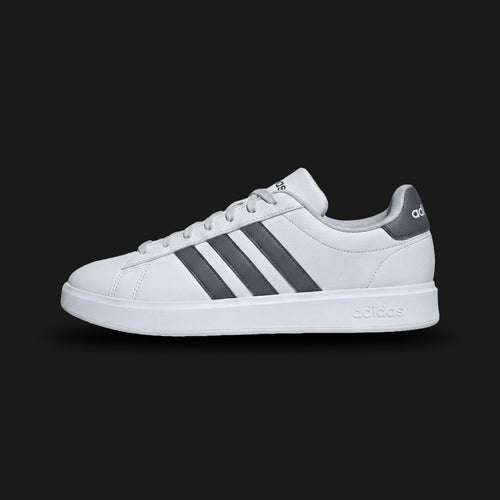 adidas Grand Court 2.0 shoes in Dash Grey, Grey Six, and Cloud White (Design Code: GW9252). Featuring a premium soft suede-like synthetic upper in Dash Grey with contrasting darker Grey Six three-stripes and heel detailing. Equipped with a plush Cloudfoam Comfort sockliner for superior cushioning and a durable Cloud White rubber cupsole. Luxuntique offers 100% authentic adidas lifestyle sneakers at the lowest price in Sri Lanka.