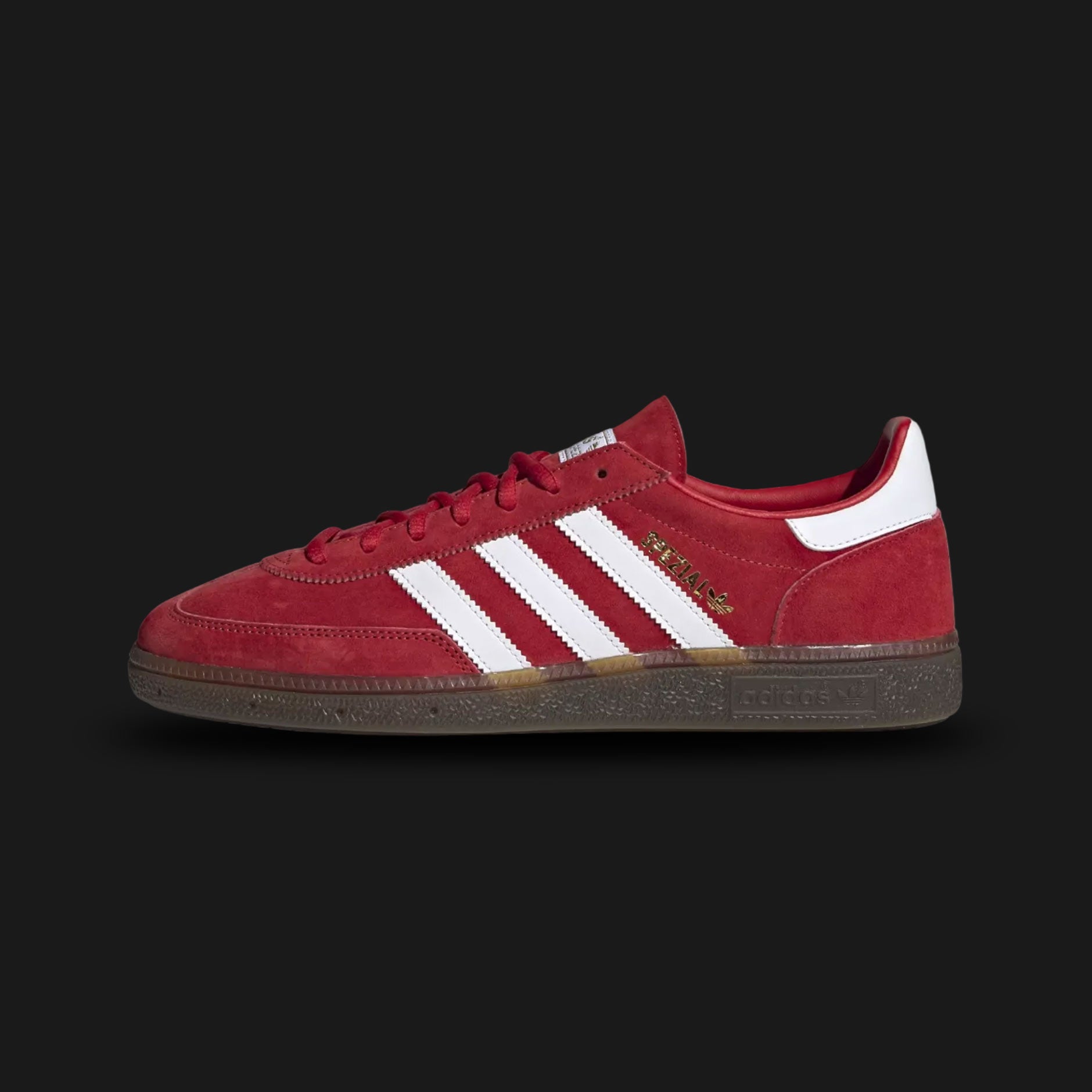 adidas Handball Spezial shoes in Scarlet, Cloud White, and Gum (Design Code: FV1227). Featuring a premium pigskin nubuck suede upper in vibrant red, contrasting white serrated three-stripes, and the iconic gold-foil "Spezial" branding on the side. Finished with a dark gum rubber outsole with a vintage traction pattern. Luxuntique offers 100% authentic adidas terrace sneakers at the lowest price in Sri Lanka.
