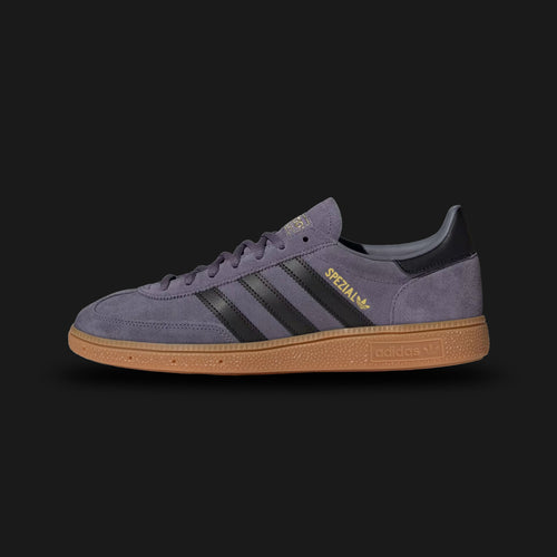 Adidas Handball Spezial shoes in Preloved Violet, Core Black, and Gold Metallic (JR3847). Features a premium soft suede upper, classic leather Three-Stripes, a retro T-toe overlay, and a low-profile gum rubber outsole. Luxuntique guarantees 100% authentic "Adidas" footwear in Sri Lanka.