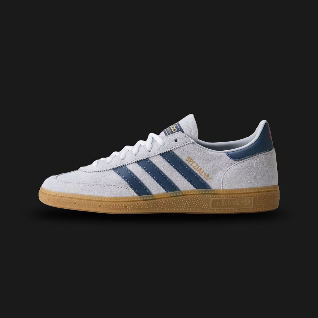 Adidas Italy Handball Spezial shoes in Off White and Blue Bird (HP3671). Features a federation edition premium soft leather upper, vibrant blue Three-Stripes and heel tab, a vintage T-toe overlay, and a classic low-profile gum rubber outsole. Luxuntique guarantees 100% authentic footwear.