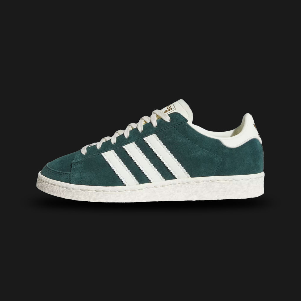 Adidas Jabbar Lo shoes in Aurora Ivy and Off White (JR4354). Features a premium smooth leather upper in forest green with serrated off-white 3-Stripes and a suede T-toe overlay. Classic low-profile 1970s basketball silhouette with an aged-look rubber cupsole and Kareem Abdul-Jabbar tongue branding. Luxuntique offers 100% authentic Adidas in Sri Lanka.