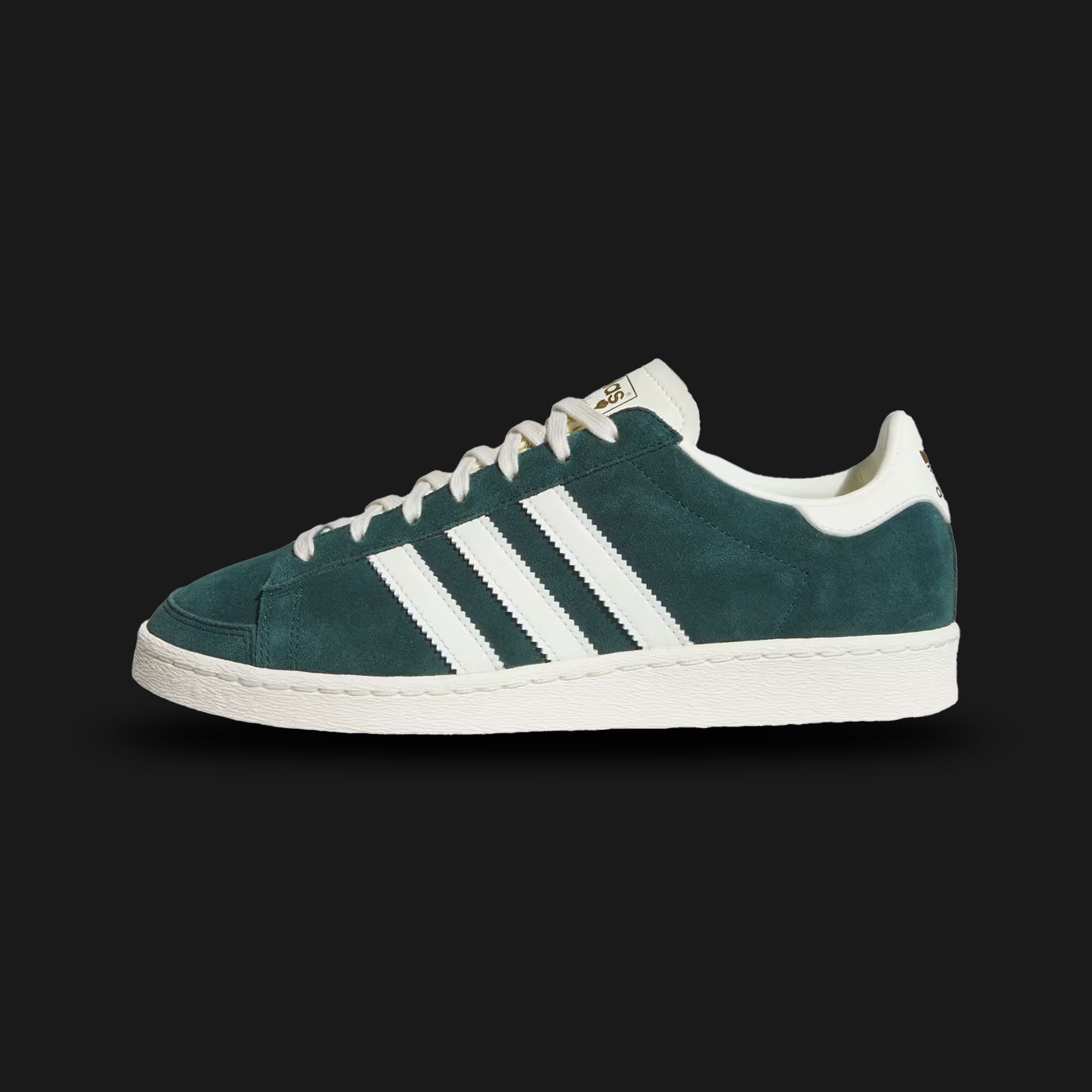 Adidas Jabbar Lo shoes in Aurora Ivy and Off White (JR4354). Features a premium smooth leather upper in forest green with serrated off-white 3-Stripes and a suede T-toe overlay. Classic low-profile 1970s basketball silhouette with an aged-look rubber cupsole and Kareem Abdul-Jabbar tongue branding. Luxuntique offers 100% authentic Adidas in Sri Lanka.
