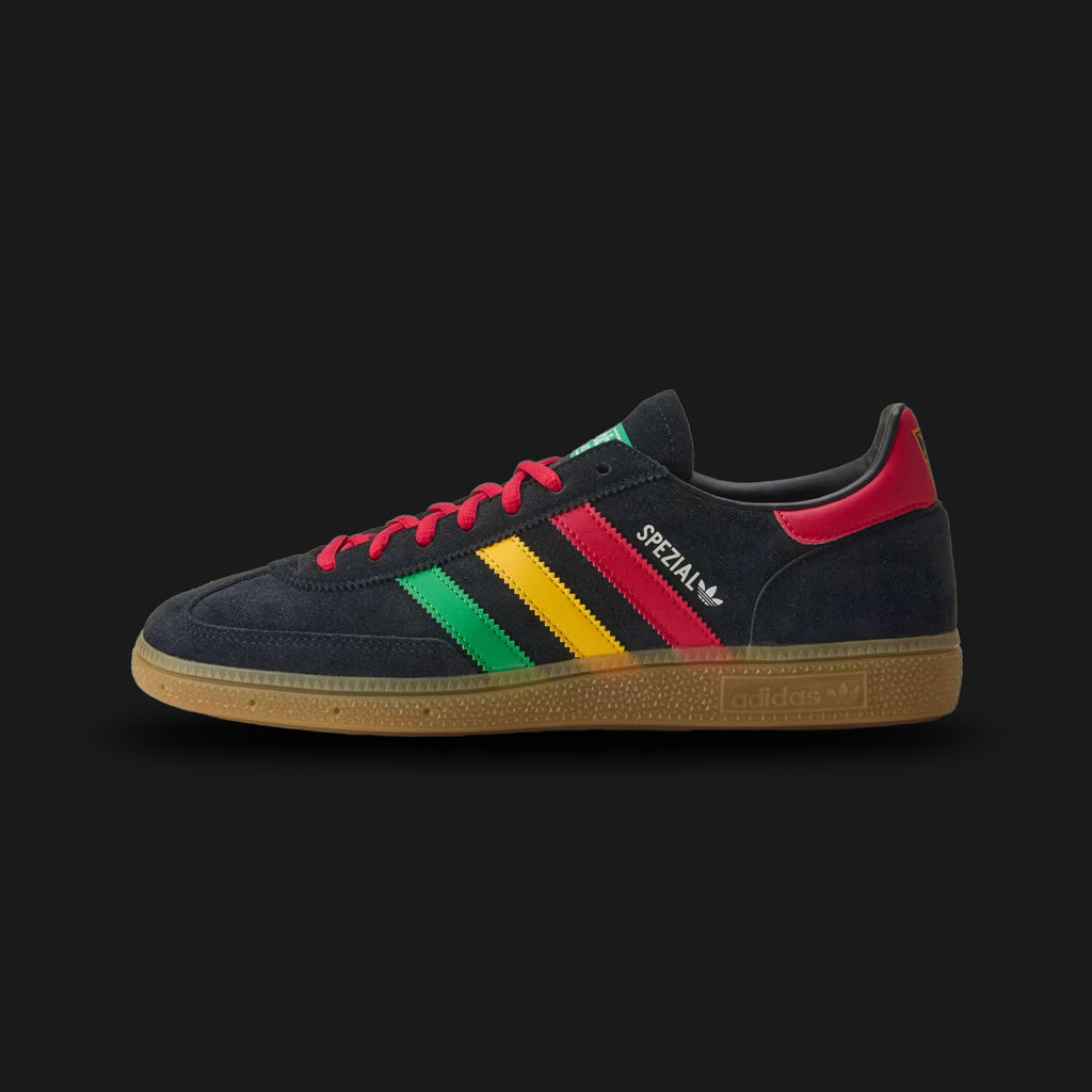 Adidas Jamaica Handball Spezial shoes in Core Black, Pure Ruby, and Bold Gold (HQ9437). Features a premium black suede upper with vibrant red and yellow leather serrated 3-Stripes and a Bold Gold heel tab. Metallic gold Spezial branding on the lateral side and a classic translucent gum rubber cupsole. Luxuntique offers 100% authentic Adidas in Sri Lanka.