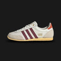 Adidas Japan shoes in Off White, Shadow Red, and Orange Tint (JI2662). Features a premium Off White leather upper with deep Shadow Red Three Stripes and subtle Orange Tint accents. Iconic low-profile 1964 archival design with a slim, flexible rubber outsole. Luxuntique offers 100% authentic Adidas in Sri Lanka.