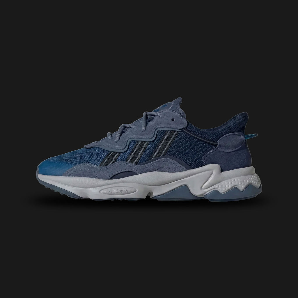 Adidas OZWEEGO shoes in Dark Marine, Preloved Ink, and Night Indigo (Design Code: ID0672). Featuring a tonal blue layered mesh and suede upper, signature Adiprene+ forefoot cushioning, and Adiprene heel cushioning for high-impact absorption. Includes the iconic translucent support tube and chunky EVA midsole. Luxuntique offers 100% authentic Adidas OZWEEGO sneakers at the lowest price in Sri Lanka
