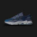 Adidas OZWEEGO shoes in Dark Marine, Preloved Ink, and Night Indigo (Design Code: ID0672). Featuring a tonal blue layered mesh and suede upper, signature Adiprene+ forefoot cushioning, and Adiprene heel cushioning for high-impact absorption. Includes the iconic translucent support tube and chunky EVA midsole. Luxuntique offers 100% authentic Adidas OZWEEGO sneakers at the lowest price in Sri Lanka
