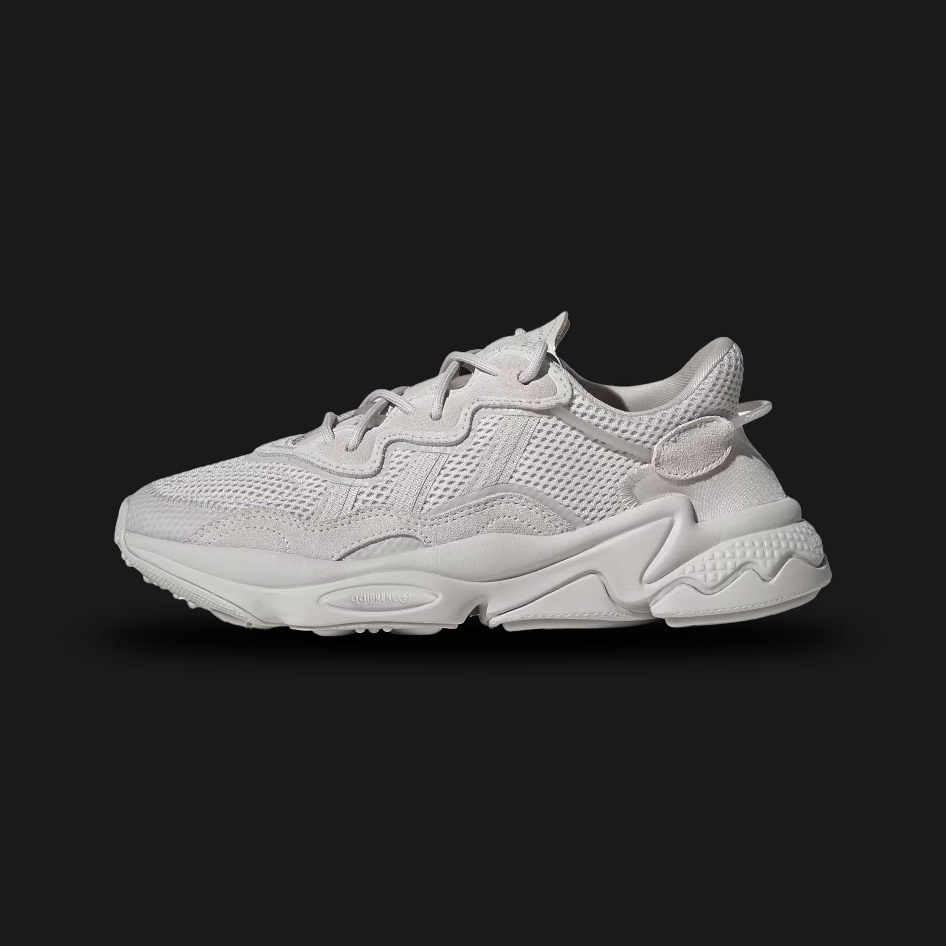 Adidas OZWEEGO shoes in Chalk Pearl and Cloud White (FY2023). Features a retro-futuristic layered upper with premium suede, mesh, and TPU overlays. Includes the signature translucent nylon support tube, Adiprene+ forefoot cushioning, and Adiprene heel cushioning in a chunky EVA midsole. Luxuntique offers 100% authentic Adidas in Sri Lanka.