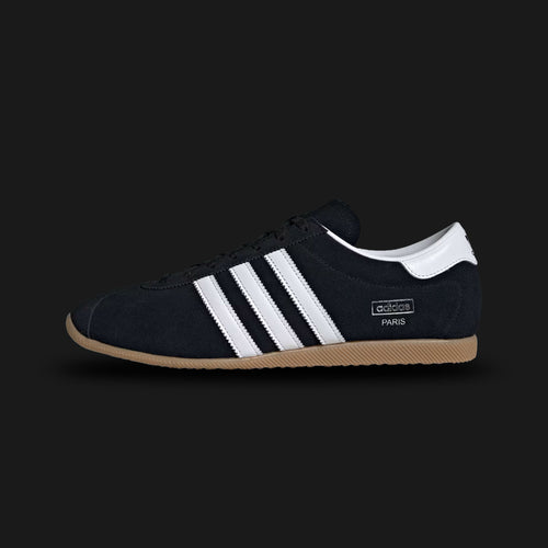Adidas Paris shoes in Core Black, Cloud White, and Gum (KJ1012). Features a premium soft black leather upper with crisp white Three Stripes and metallic gold "Paris" branding. Classic low-profile 1970s archival design with a thin gum rubber outsole. Luxuntique offers 100% authentic Adidas in Sri Lanka.