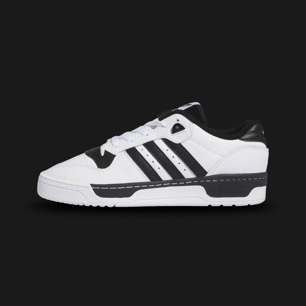Adidas Rivalry Low shoes in Cloud White and Core Black (IG1474). Features a retro 80s basketball-inspired premium leather upper, perforated toe box details, and a durable stitched rubber cupsole. Luxuntique guarantees 100% authentic "Adidas" performance footwear in Sri Lanka.