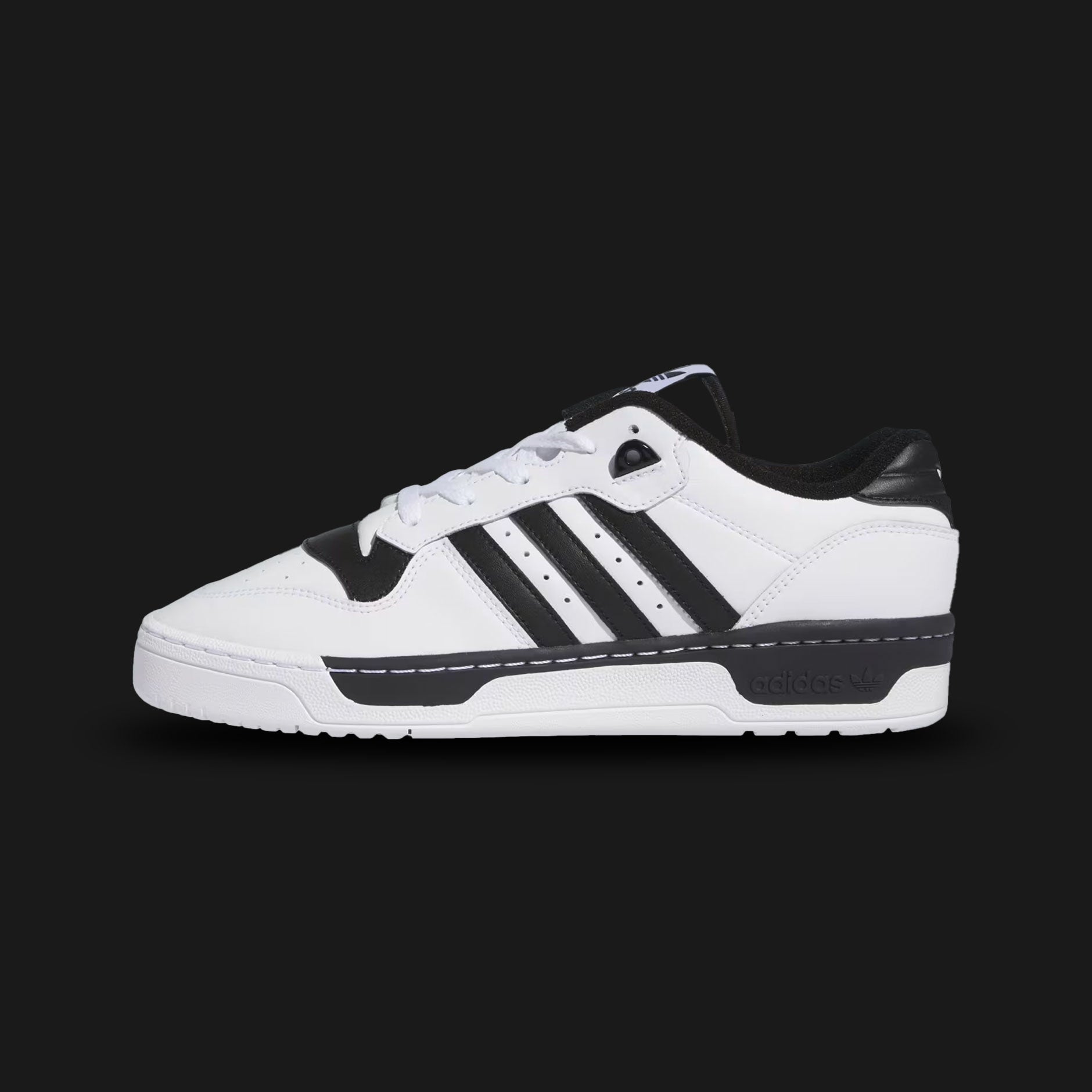 Adidas Rivalry Low shoes in Cloud White and Core Black (IG1474). Features a retro 80s basketball-inspired premium leather upper, perforated toe box details, and a durable stitched rubber cupsole. Luxuntique guarantees 100% authentic "Adidas" performance footwear in Sri Lanka.
