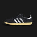 Adidas Samba OG shoes in Core Black, Matte Silver, and Almost Yellow (IE8128). Features a classic low-profile terrace design with a premium leather upper, a contrast suede T-toe overlay, matte silver Three-Stripes, and a durable gum rubber sole. Luxuntique guarantees 100% authentic footwear in Sri Lanka.