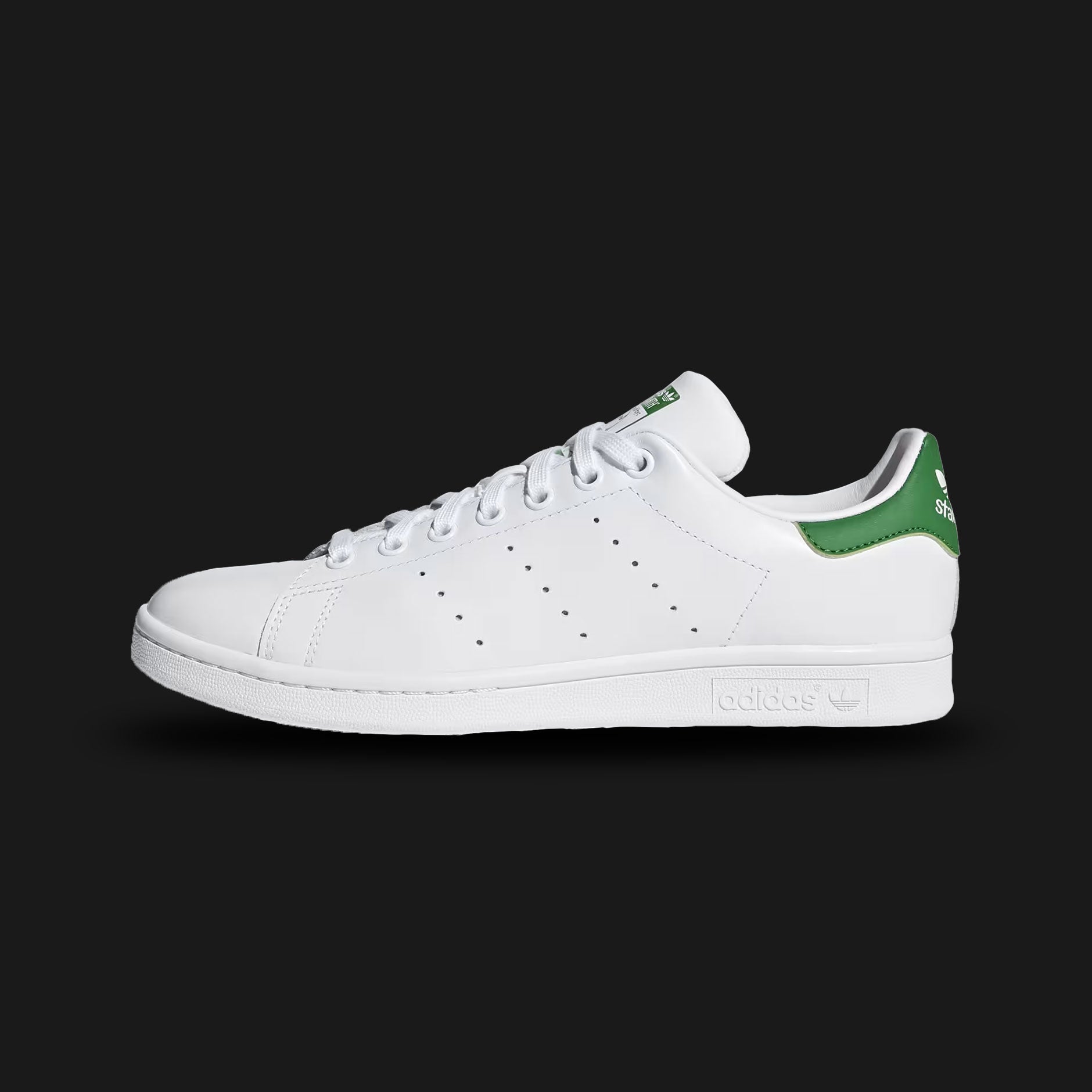 adidas Stan Smith shoes in Cloud White, Core White, and Green (Design Code: GW9253). Featuring the iconic smooth synthetic upper made with Primegreen high-performance recycled materials. Accented by the classic Green heel tab and the signature Stan Smith tongue portrait. Finished with perforated three-stripes and a durable rubber cupsole. Luxuntique offers 100% authentic adidas iconic lifestyle sneakers at the lowest price in Sri Lanka.