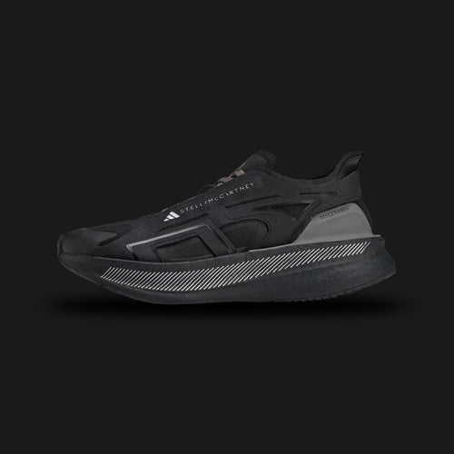 Adidas by Stella McCartney Ultraboost 5 shoes in Core Black, Crew Orange, and Charcoal (IE8771). Features a sustainable, breathable Core Black synthetic mesh upper encased in distinct Charcoal supportive overlays. Includes a thick, energy-returning Boost foam midsole, striking Crew Orange designer accents, and a durable rubber outsole. Luxuntique guarantees 100% authentic Adidas footwear in Sri Lanka.
