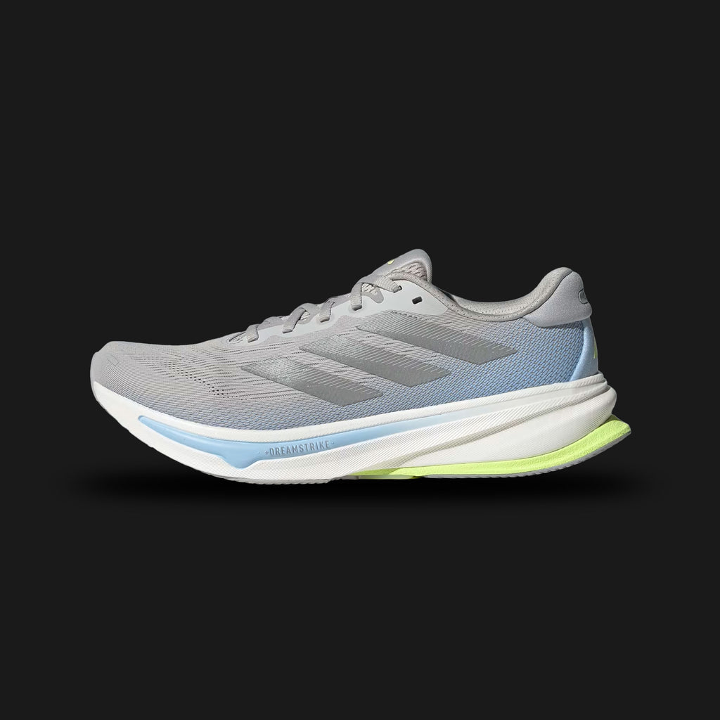 Adidas Supernova Rise 2 running shoes in Grey Two, Matte Silver, and Hi-Res Yellow (IH8708). Features a breathable engineered mesh upper, metallic 3-Stripes, responsive Dreamstrike+ foam cushioning midsole, and Adiwear outsole. Luxuntique guarantees 100% authentic footwear.