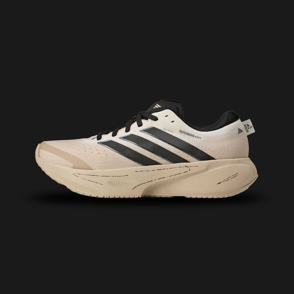 adidas Supernova Rise 3 running shoes in Off White, Core Black, and Onix (KI3617). Features a breathable Off White engineered mesh upper, a plush Dreamstrike+ foam midsole for daily running comfort, and a bottom Support Rod system for smooth transitions. Includes sharp Core Black accents and a durable Adiwear outsole. Luxuntique offers 100% authentic adidas in Sri Lanka.