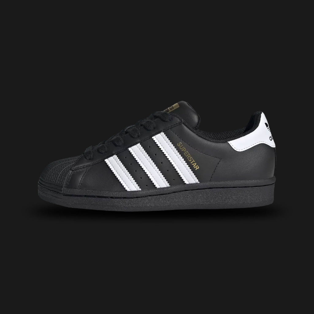 Black Adidas Superstar sneaker with white stripes (Design code: EF5398) on a light gray background. Luxuntique offers 100% authentic Adidas sneakers at the lowest prices in Sri Lanka.
