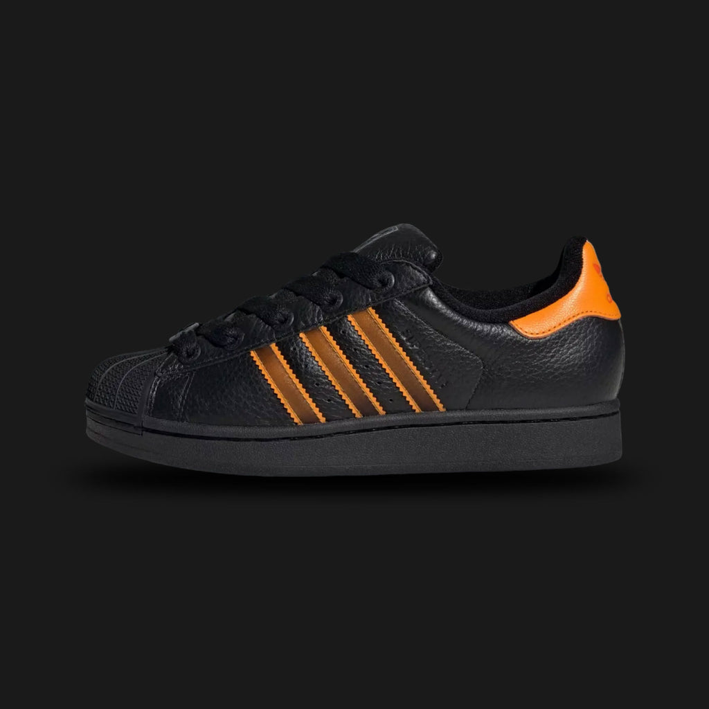 Black Adidas Superstar II Shoes with orange accents on a light gray background. Luxuntique offers authentic Adidas footwear at the lowest prices in Sri Lanka.