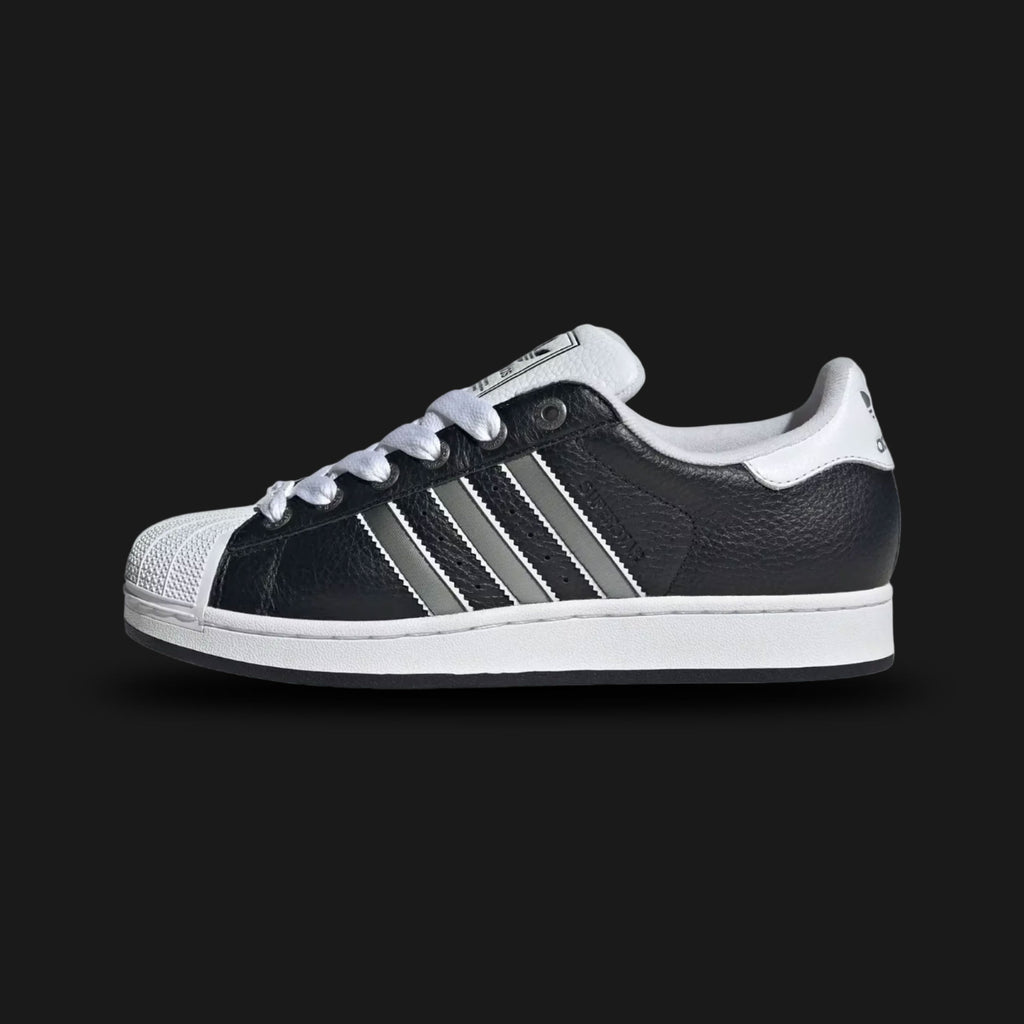 adidas Superstar II shoes in Core Black, Matte Silver, and Cloud White (Design Code: JQ3209). Featuring the iconic white rubber shell toe, serrated Matte Silver three-stripes on a premium black leather upper, and a classic herringbone-pattern rubber cupsole for traction. Luxuntique offers 100% authentic adidas Superstar sneakers at the lowest price in Sri Lanka.
