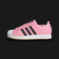 Adidas Superstar Messi shoes in Light Pink, Core Black, and Gold Metallic (JR1520). Features an Inter Miami inspired premium leather upper, iconic rubber shell toe, serrated Three-Stripes, and a durable rubber cupsole. Luxuntique guarantees 100% authentic footwear in Sri Lanka.