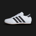 Adidas Taekwondo Lace shoes in Cloud White, Core Black, and Gum (JS1194). Features a premium soft white leather upper with traditional lacing, iconic black Three Stripes, and a thin, low-profile gum rubber outsole for a minimal martial-arts aesthetic. Luxuntique offers 100% authentic Adidas in Sri Lanka.
