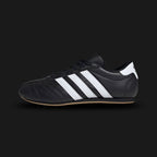 Adidas Taekwondo Lace shoes in Core Black, Cloud White, and Gum (JS1193). Features a premium soft black leather upper with traditional lacing, iconic white Three Stripes, and a thin, low-profile gum rubber outsole for a sleek, minimal martial-arts aesthetic. Luxuntique offers 100% authentic Adidas in Sri Lanka.