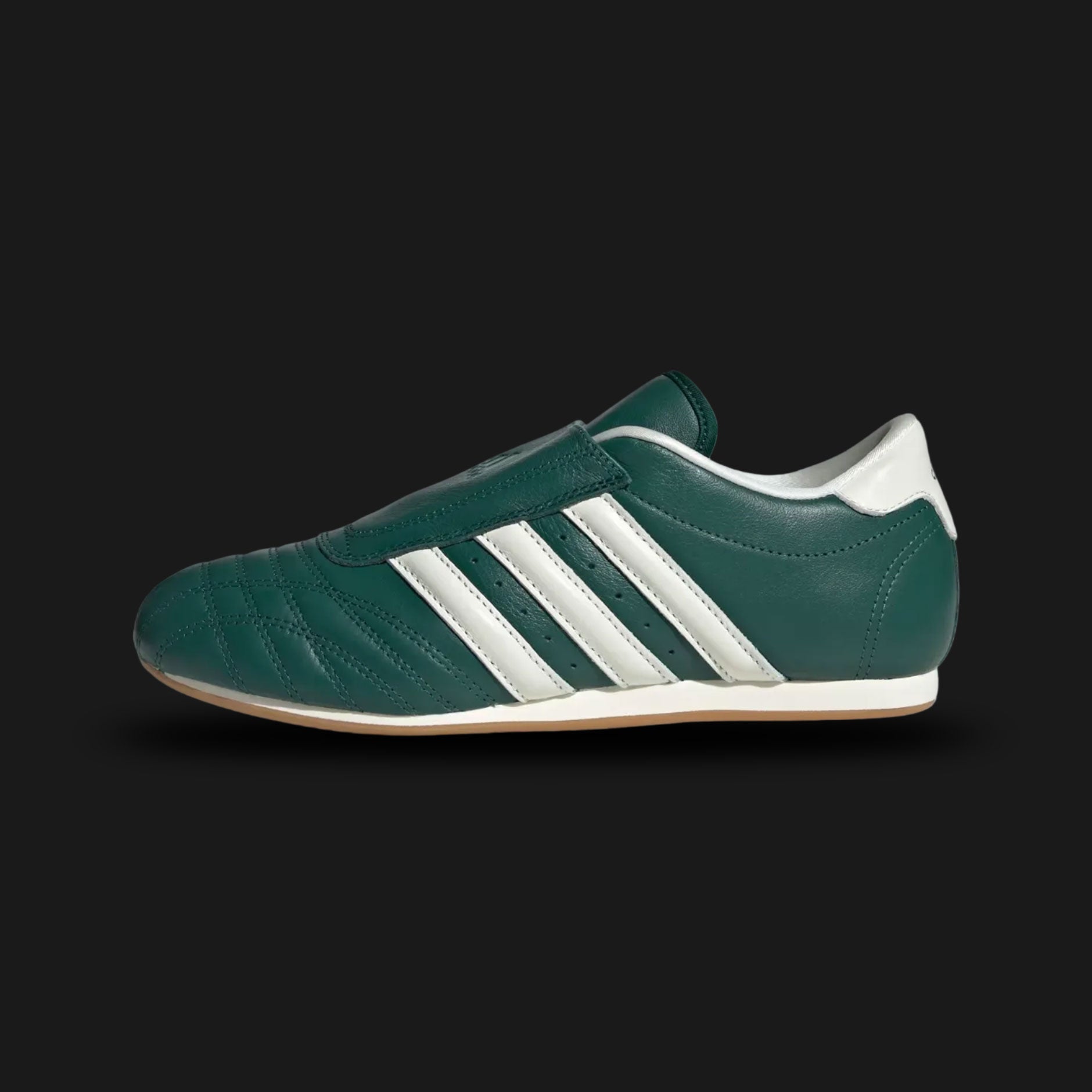 Adidas Taekwondo shoes in Collegiate Green, Off White, and Gum (JS4526). Features a premium soft leather slip-on upper in Off White with vibrant Collegiate Green Three Stripes and a thin, low-profile gum rubber outsole. Designed for a sleek, minimal martial-arts aesthetic. Luxuntique offers 100% authentic Adidas in Sri Lanka.