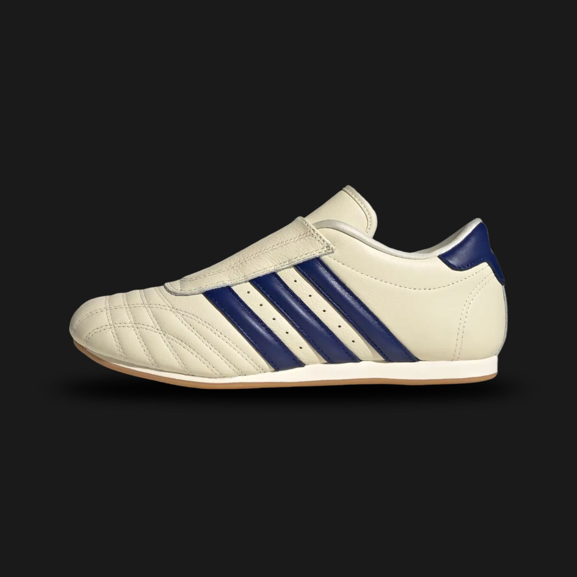 Adidas Taekwondo shoes in Cream White, Victory Blue, and Gum (JS4528). Features a premium soft leather slip-on upper in Cream White with iconic Victory Blue Three Stripes and a thin, low-profile gum rubber outsole. Designed for a sleek, minimal aesthetic. Luxuntique offers 100% authentic Adidas in Sri Lanka.