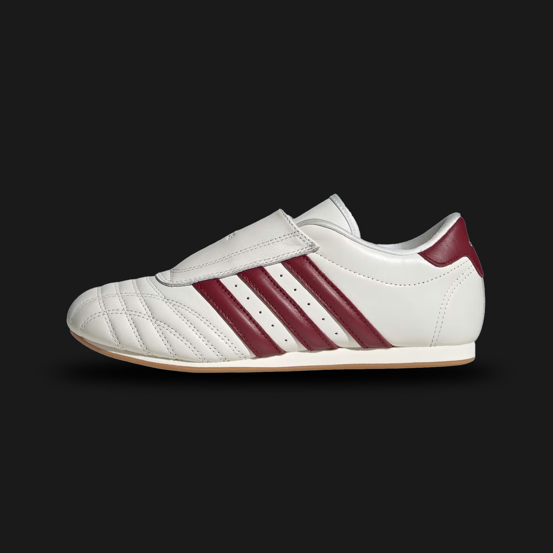 Adidas Taekwondo shoes in Off White, Noble Maroon, and Gum (JS4527). Features a premium soft leather slip-on upper in Off White with striking Noble Maroon Three Stripes and a thin, low-profile gum rubber outsole. Designed for a sleek, minimal martial-arts aesthetic. Luxuntique offers 100% authentic Adidas in Sri Lanka.