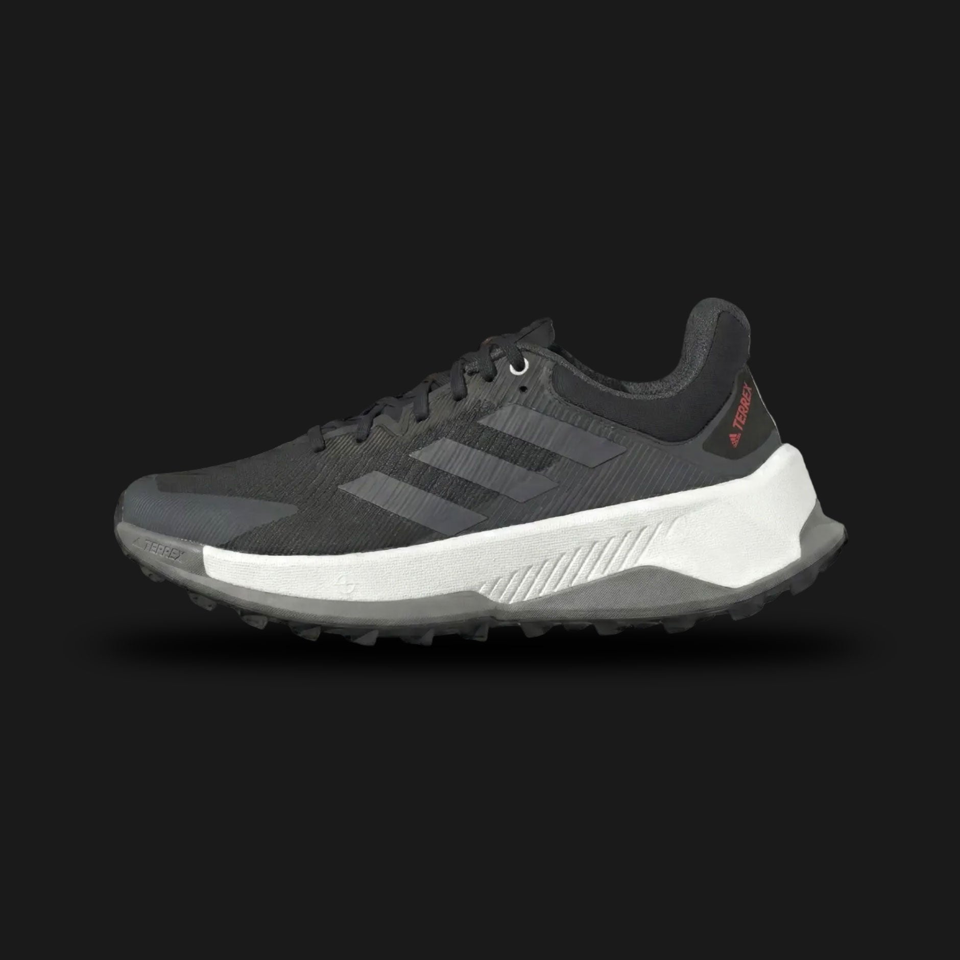 adidas Terrex Soulstride Ultra trail running shoes in Core Black, Grey Four, and Impact Orange (Design Code: IE8453). Featuring a breathable engineered mesh upper with protective grey overlays and striking Impact Orange branding. Equipped with a maximalist, ultra-thick REPETITOR+ midsole for extreme long-distance cushioning and a rugged Continental™ Rubber outsole for superior grip on unpredictable terrain. Luxuntique offers 100% authentic adidas Terrex outdoor footwear at the lowest price in Sri Lanka.