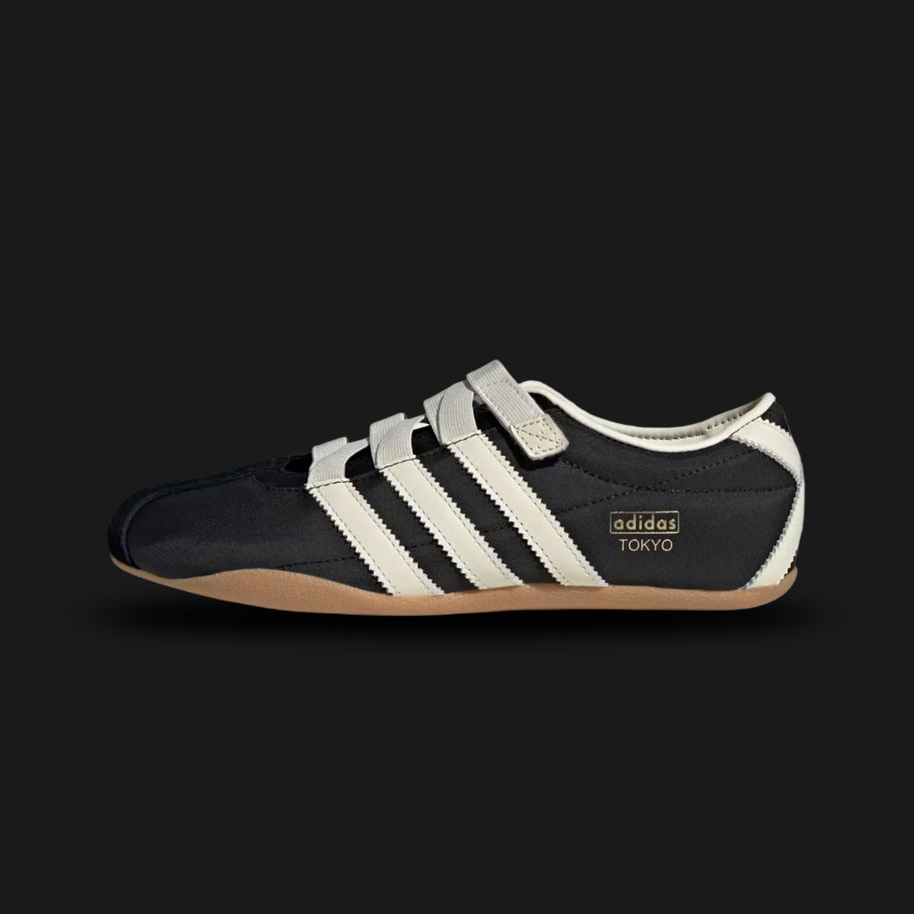 Adidas Tokyo MJ shoes in Core Black, Cream White, and Gold Metallic (JR4790). This Mary Jane-inspired sneaker features a premium black leather upper with a signature strap, cream white Three Stripes, and gold foil branding. Low-profile heritage design with a slim rubber sole. Luxuntique offers 100% authentic Adidas in Sri Lanka.