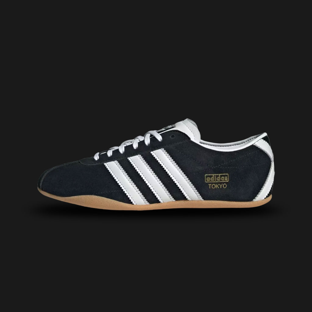 Adidas Tokyo shoes in Core Black, Cloud White, and Gum (JI0183). Features a premium black leather upper with crisp white Three Stripes and metallic gold Tokyo branding. Finished with a classic low-profile gum rubber outsole and a slim, retro-minimalist silhouette. Luxuntique offers 100% authentic Adidas in Sri Lanka.