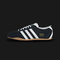 Adidas Tokyo shoes in Core Black, Cloud White, and Gum (JI0183). Features a premium black leather upper with crisp white Three Stripes and metallic gold Tokyo branding. Finished with a classic low-profile gum rubber outsole and a slim, retro-minimalist silhouette. Luxuntique offers 100% authentic Adidas in Sri Lanka.