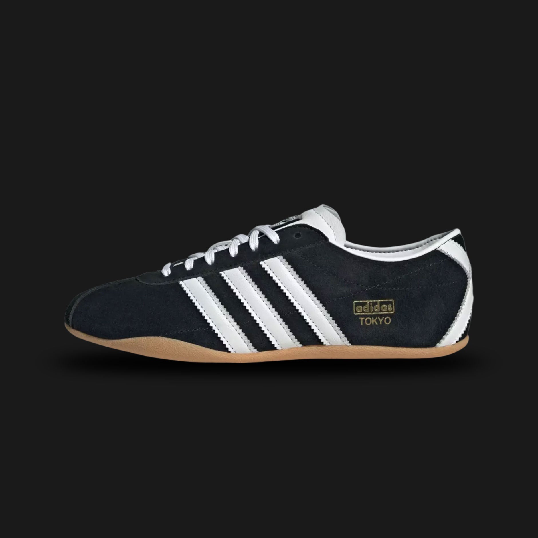 Adidas Tokyo shoes in Core Black, Cloud White, and Gum (JI0183). Features a premium black leather upper with crisp white Three Stripes and metallic gold Tokyo branding. Finished with a classic low-profile gum rubber outsole and a slim, retro-minimalist silhouette. Luxuntique offers 100% authentic Adidas in Sri Lanka.