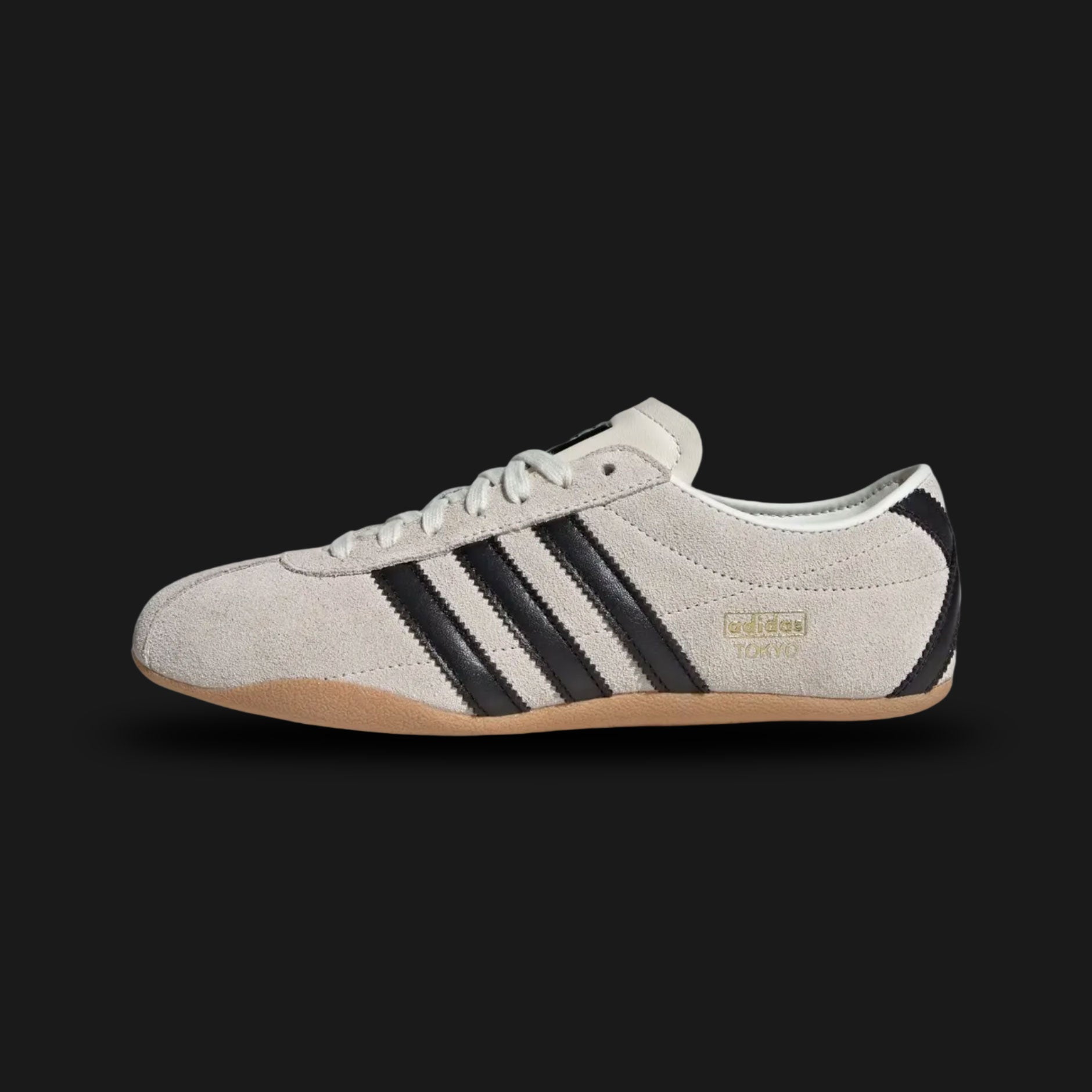 Adidas Tokyo shoes in Off White, Core Black, and Gold Metallic (JI0182). Features a premium smooth Off White leather upper with bold black Three Stripes and metallic gold "Tokyo" branding. Sleek low-profile design with a thin rubber outsole for a retro-minimalist look. Luxuntique offers 100% authentic Adidas in Sri Lanka.