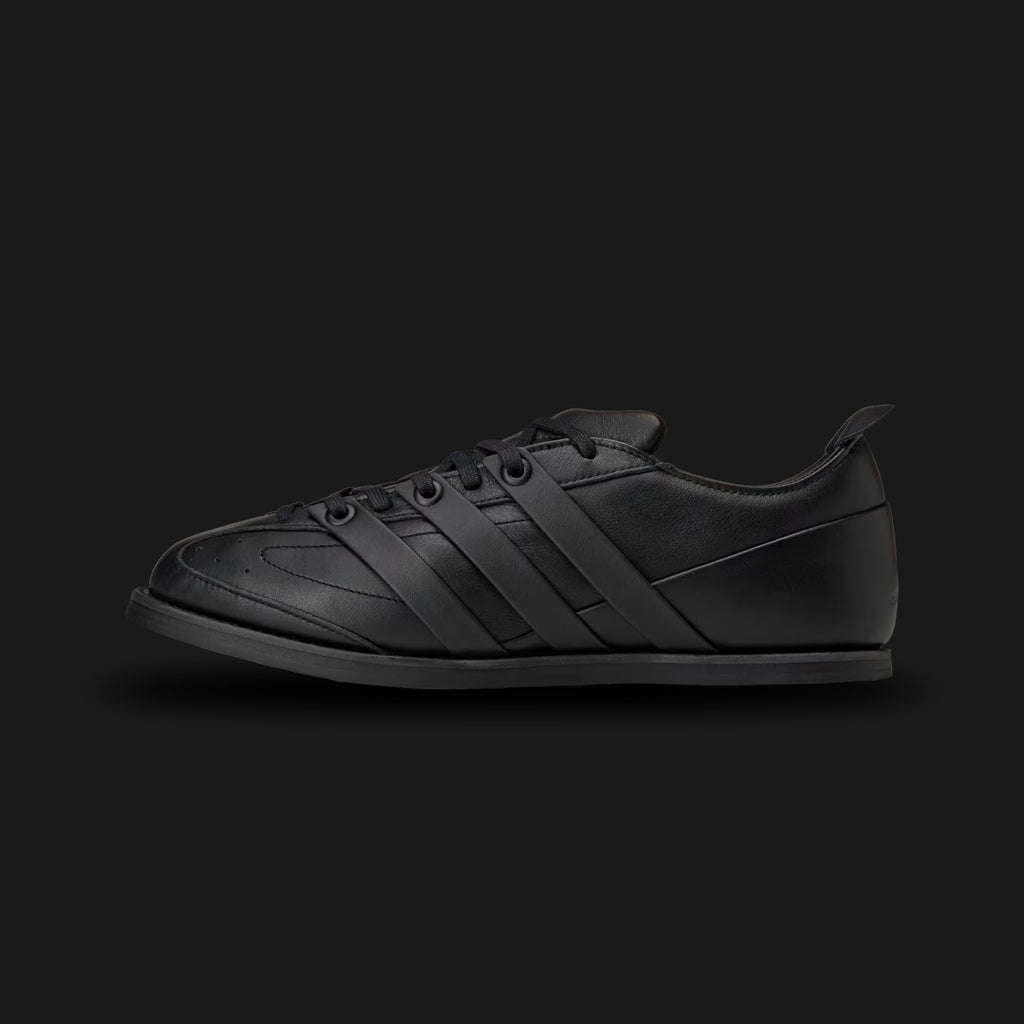 adidas x Entire Studios Ace shoes in Core Black (KI5701). Features a premium monochromatic leather and synthetic upper with a sculpted, minimalist design. Includes layered 3-stripes, an extended heel tab, a luxurious leather sockliner, and a tough rubber outsole with a lasered collaboration logo. Luxuntique offers 100% authentic adidas in Sri Lanka.
