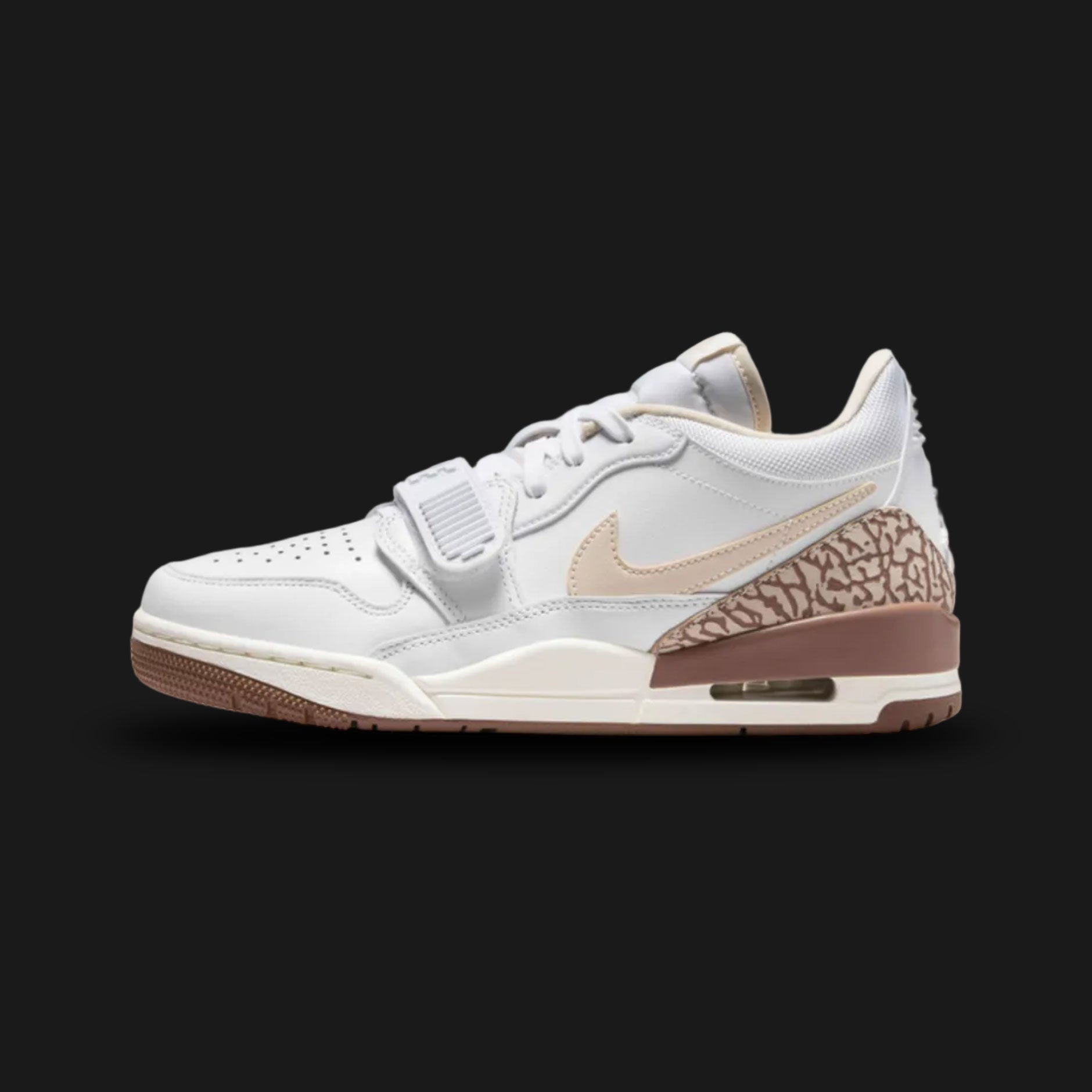 Air Jordan Legacy 312 Low lifestyle sneakers in White, Archaeo Brown, Sail, and Legend Light Brown (Design Code: FQ7827-100). Featuring a crisp, premium White leather base expertly layered with warm Legend Light Brown overlays and rich, dark Archaeo Brown accents for a sophisticated, earth-toned aesthetic. Defined by a classic midfoot lockdown strap, bold Nike Swoosh, and signature hybrid Jordan design details. Anchored by a vintage-inspired Sail foam midsole housing a visible Air Max unit in the heel, all 