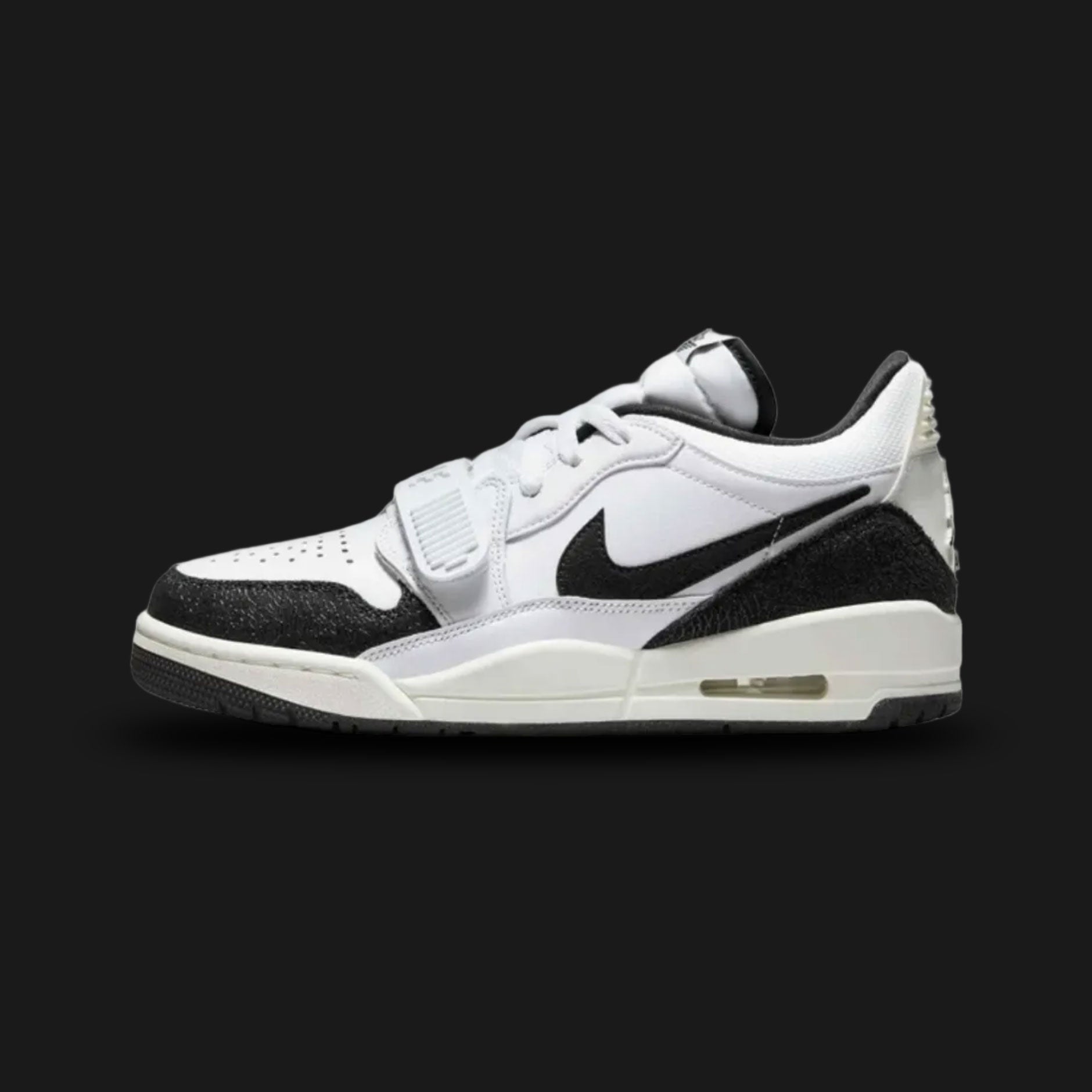 Air Jordan Legacy 312 Low lifestyle sneakers in White, Black, and Sail (Design Code: FQ7827-110). Featuring a crisp, premium White leather upper layered with signature hybrid Jordan design details. Defined by a stark, high-contrast Black adjustable midfoot lockdown strap, classic Nike Swoosh, and iconic branding. Anchored by a vintage-inspired Sail foam midsole housing a visible Air Max unit in the heel, all resting on a durable rubber outsole. Luxuntique offers 100% authentic Air Jordan footwear at the low