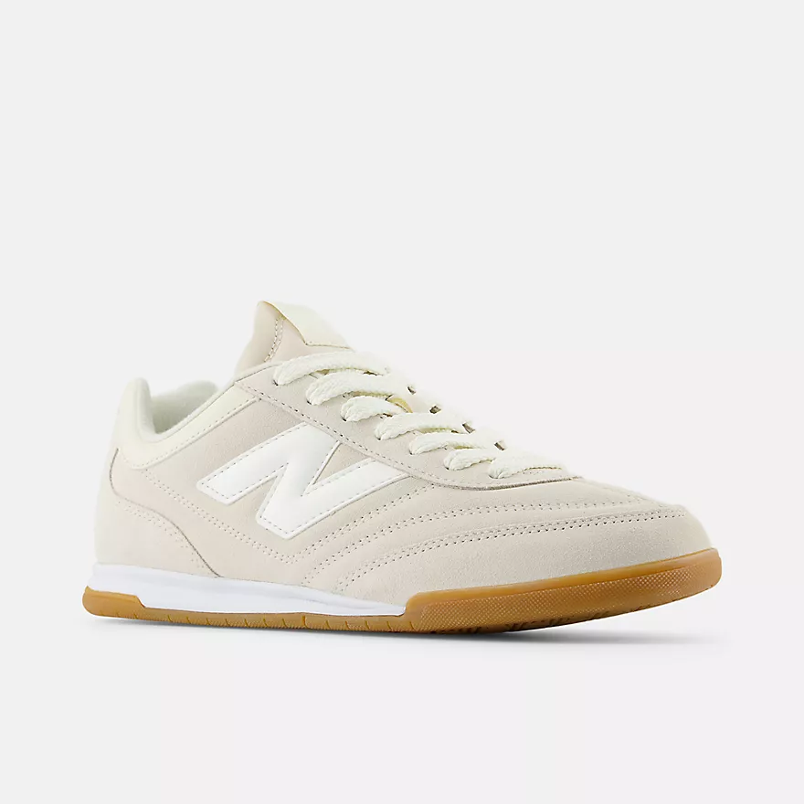New Balance RC42 URC42EA - Front 3/4 Hero Shot on Light Grey Background showing Linen Suede Upper, Sea Salt White NB Logo on Lateral Midfoot, Perforated Quarter Panel Detail, Matching Linen Flat Laces, White Midsole & Amber Gum Outsole