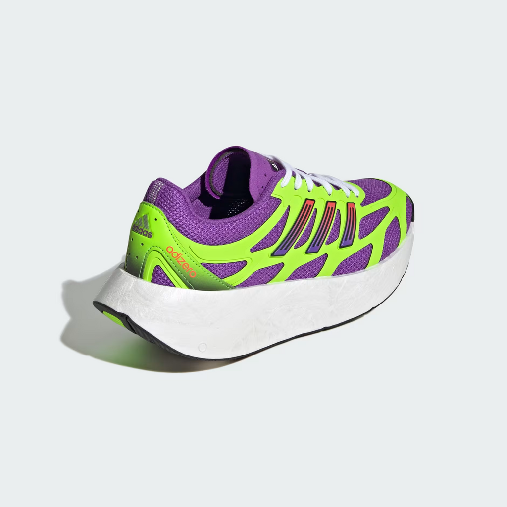 Adidas Adizero Aruku JP5566 - Outsole Close-up showing Black Rubber Traction Pattern with Solar Green Continental Rubber Pods in Zigzag Layout & White Swirl-Foam Midsole Edge